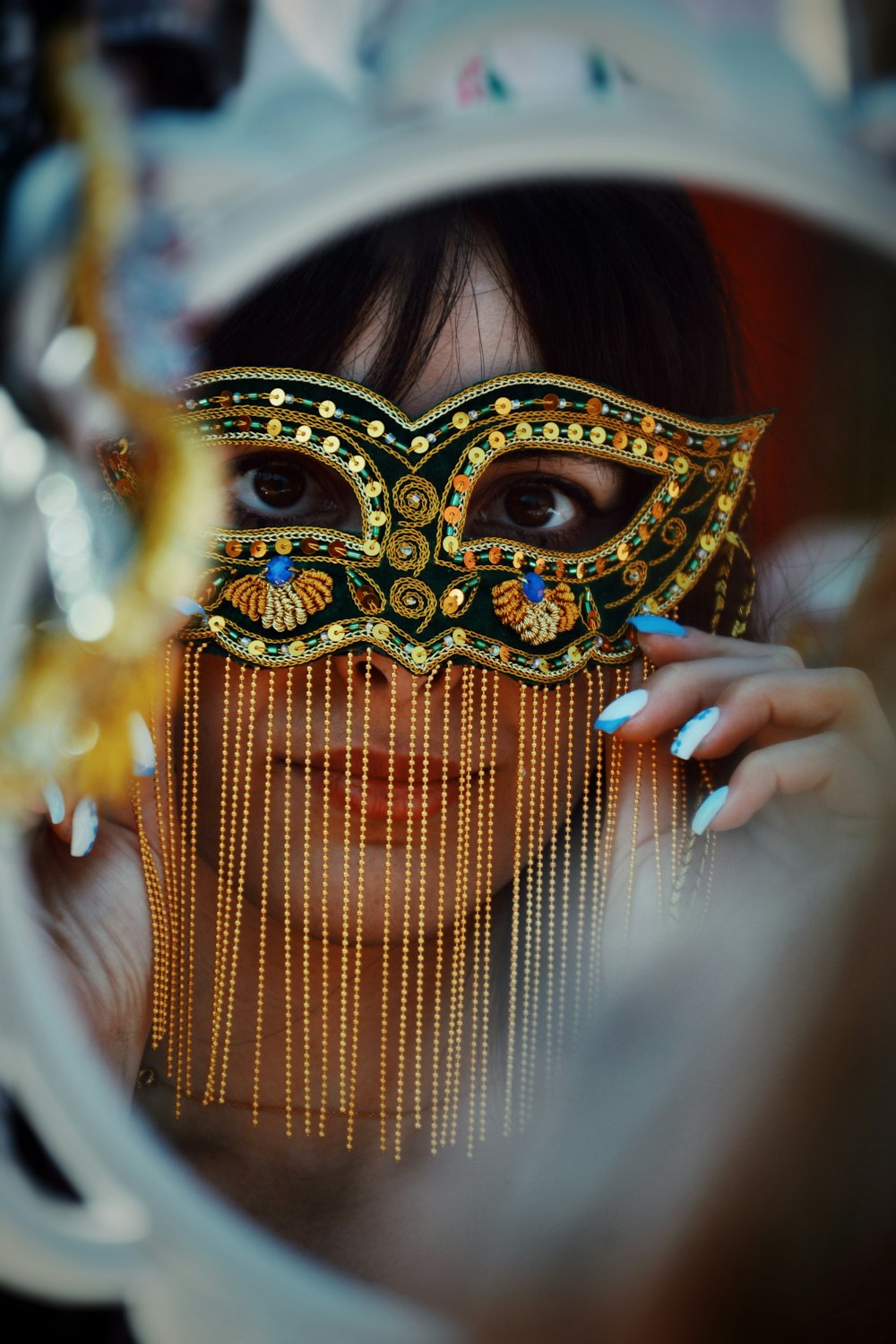 a woman wearing a mask looking through a mirror