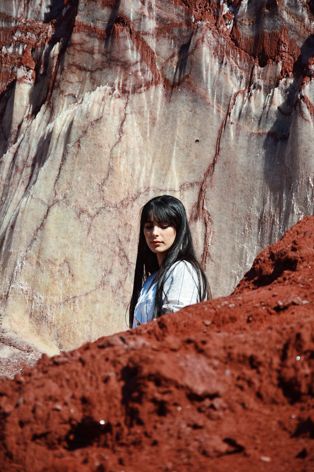 a woman standing in front of a rock formation