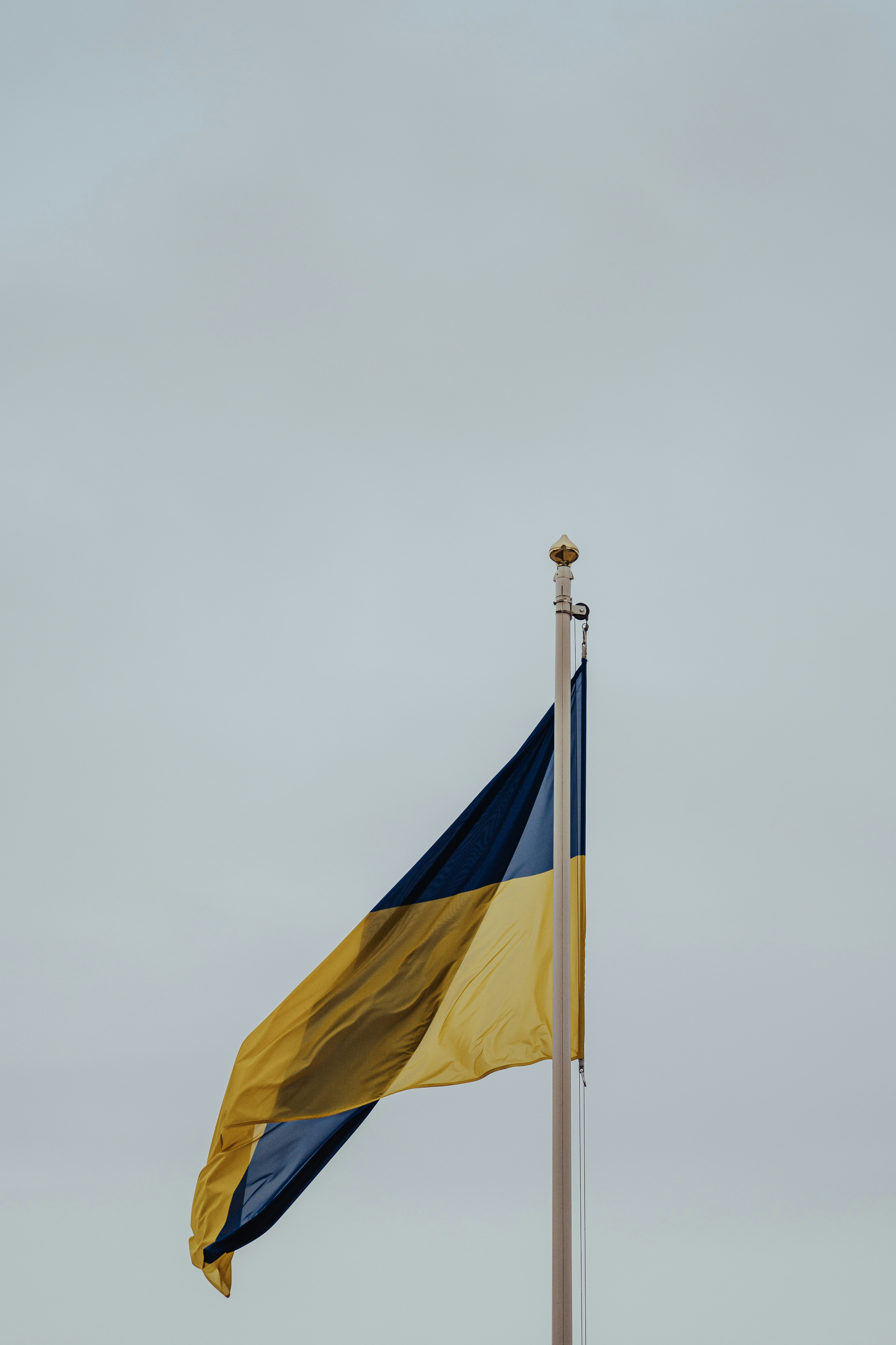 a flag flying in the wind on a pole