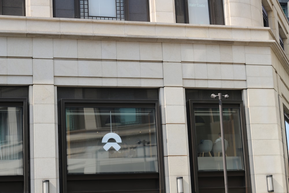 an apple logo is reflected in the windows of a building