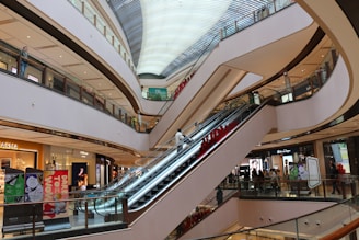 an escalator in a shopping mall with a train on it