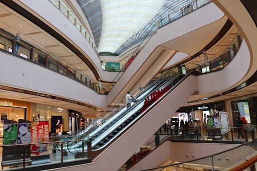 an escalator in a shopping mall with a train on it
