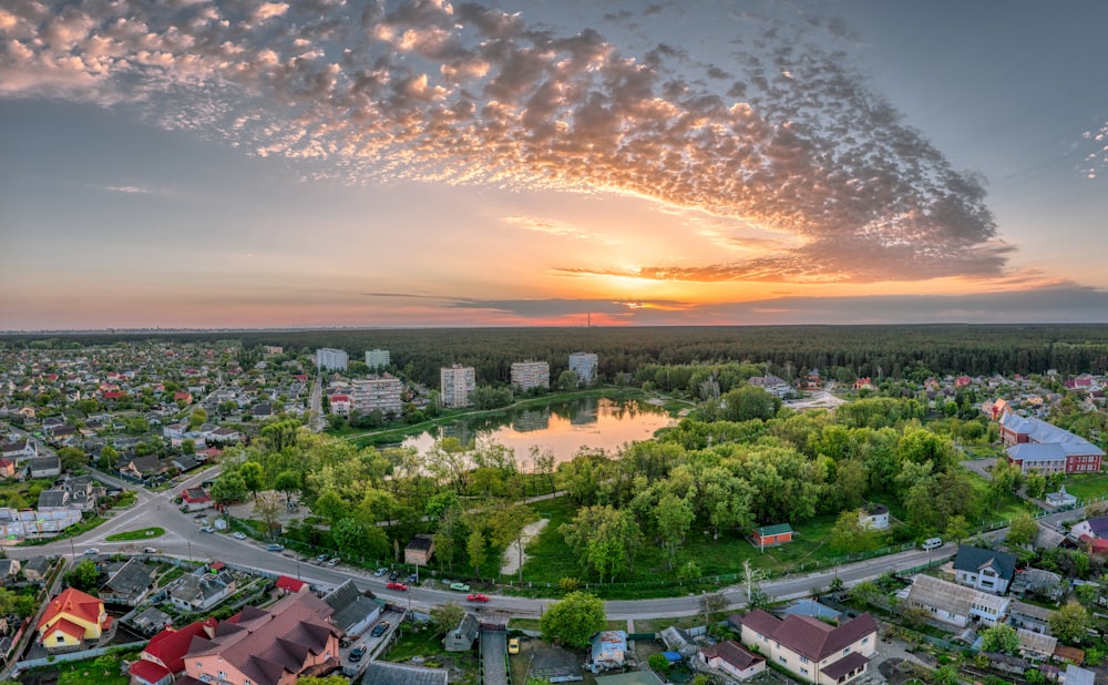 an aerial view of a city with a lake in the middle