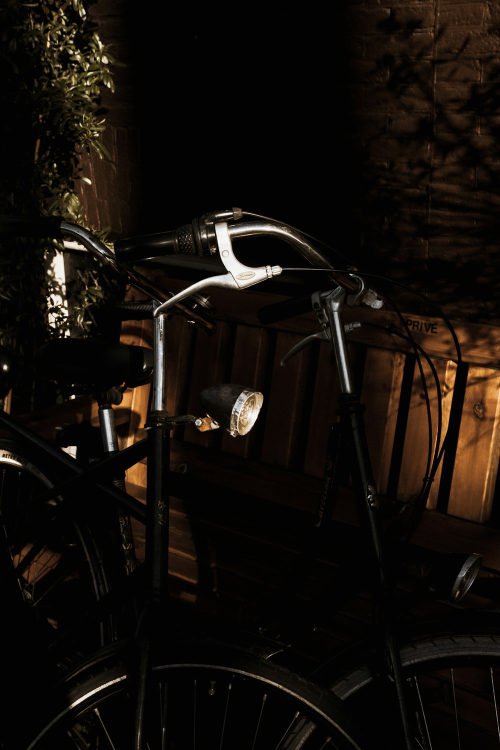 a bicycle parked next to a wooden bench