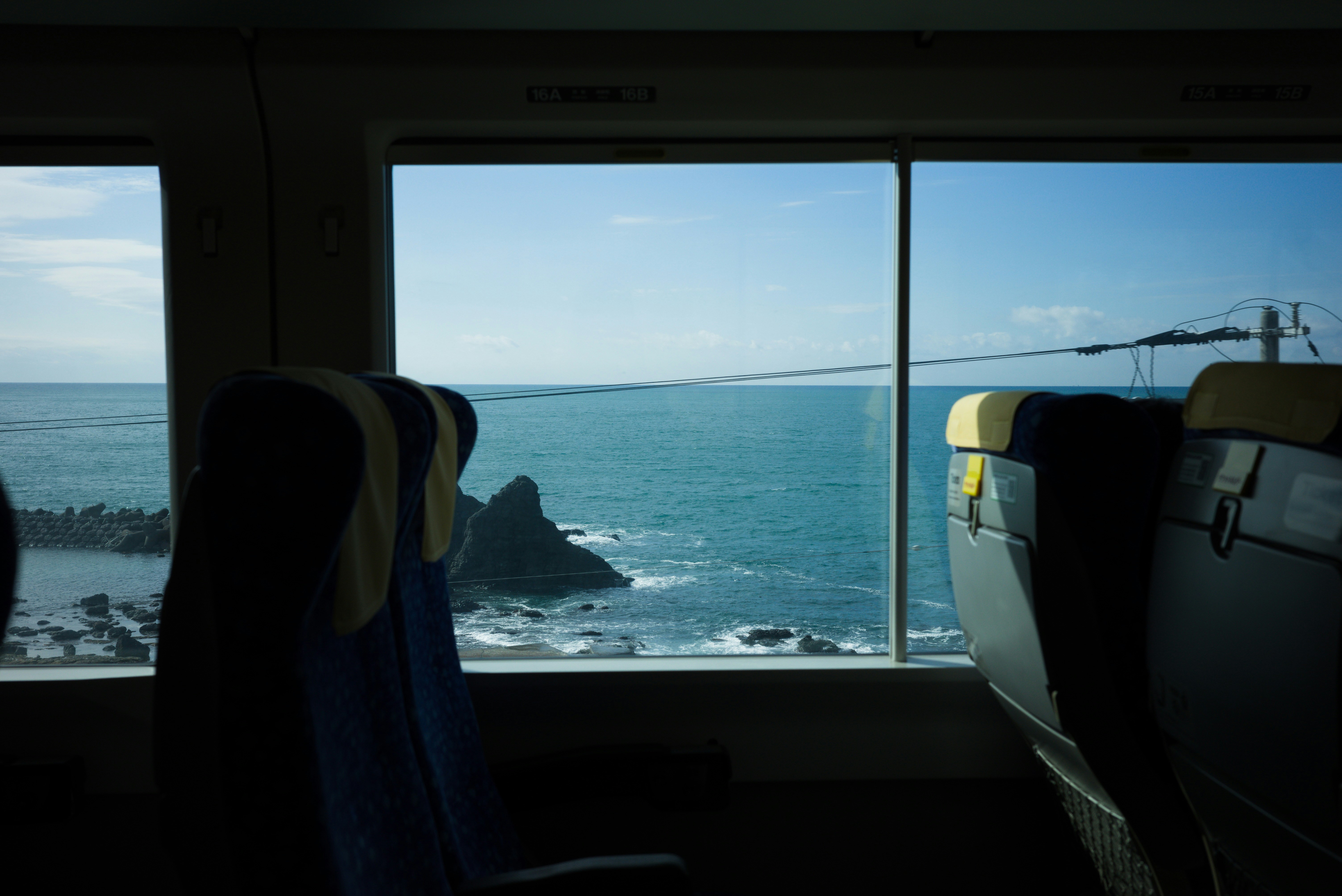 a view of the ocean from a train window