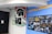 A large banner with bold black Japanese characters is displayed next to a blue wall featuring a detailed informational board. The board contains diagrams and images related to water technology or infrastructure, labeled with numbers and Japanese text. There are various colors including black, blue, and white on the board.
