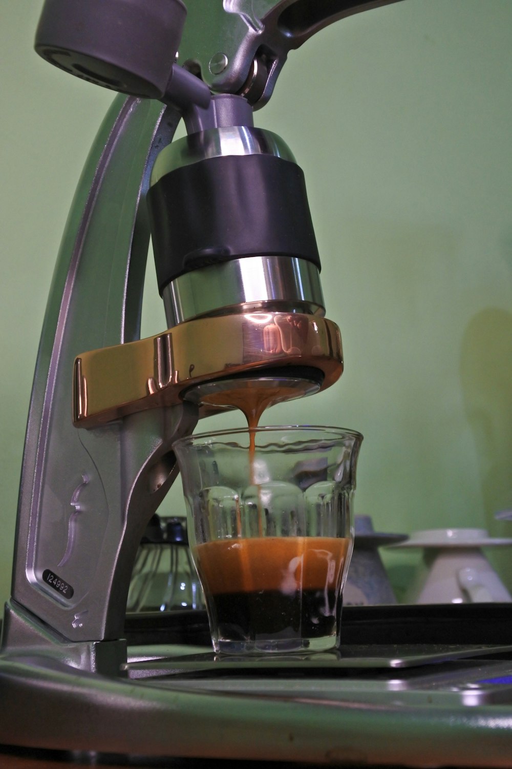 an espresso machine pouring coffee into a glass