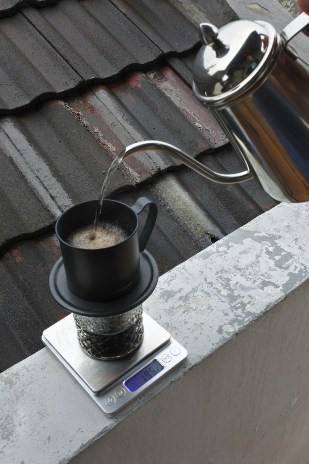 a cup of coffee on a scale on a roof
