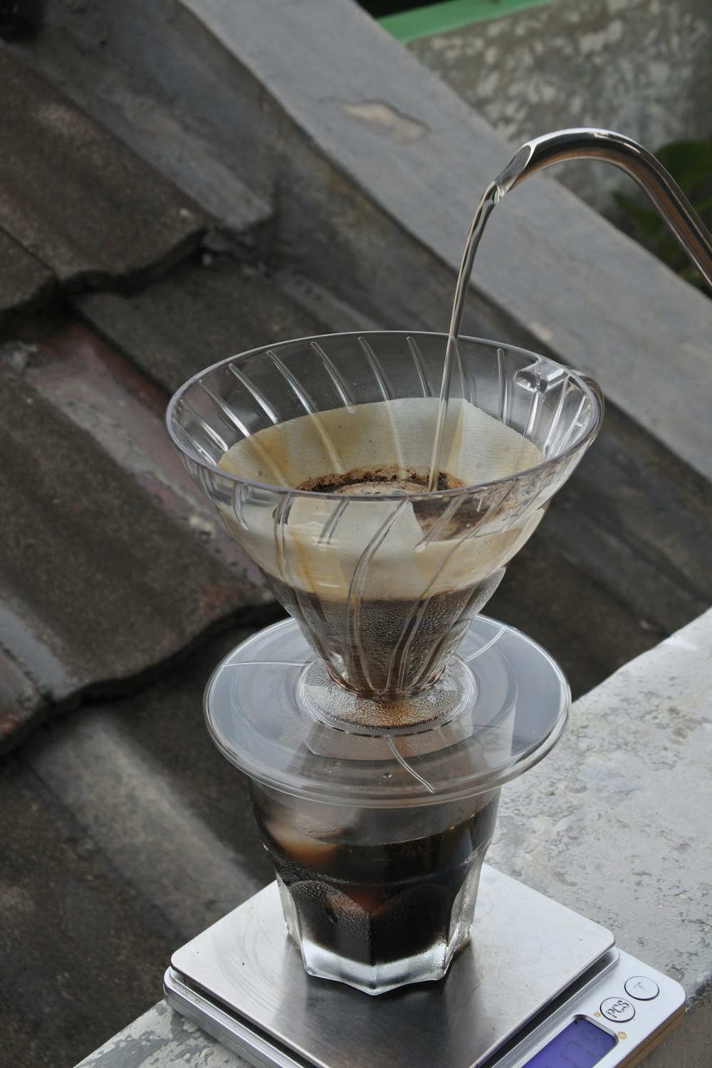 a cup of coffee being filled with liquid