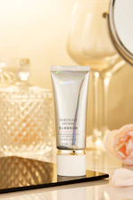 A chic display of premium hair care products with soft pink and gold accents.