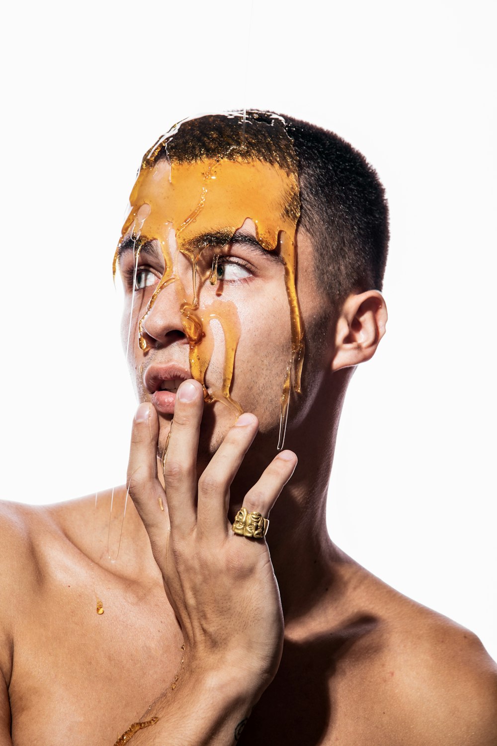 a shirtless man is eating a piece of food