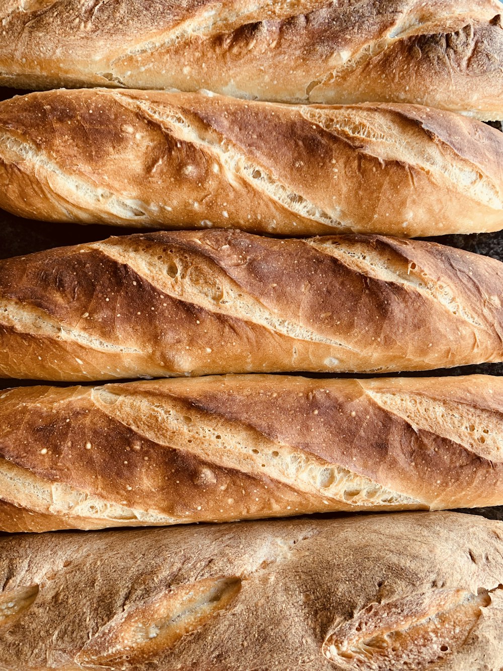 a close up of a bunch of bread loaves