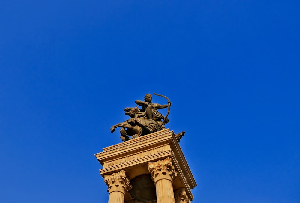 a statue of a man on a horse on top of a building