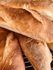 Golden naan breads cooling on racks inside the Green Street bakery.