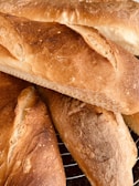 Freshly baked bread loaves cooling on a wire rack.