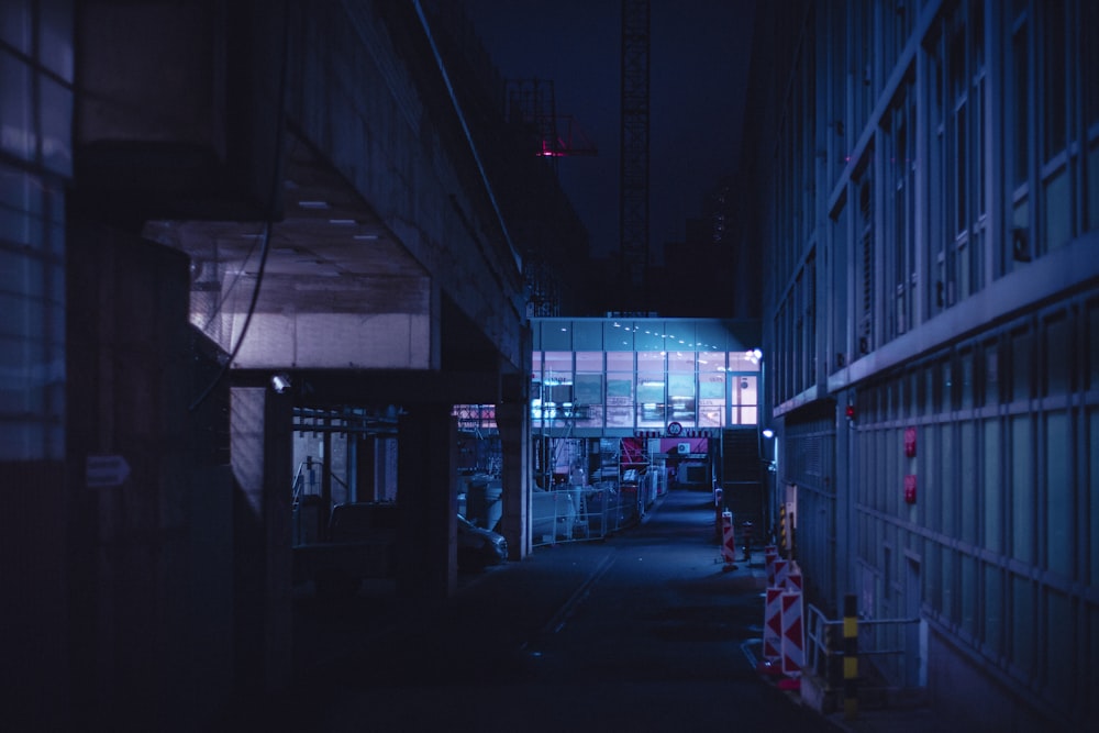 a dark alley way with a building in the background