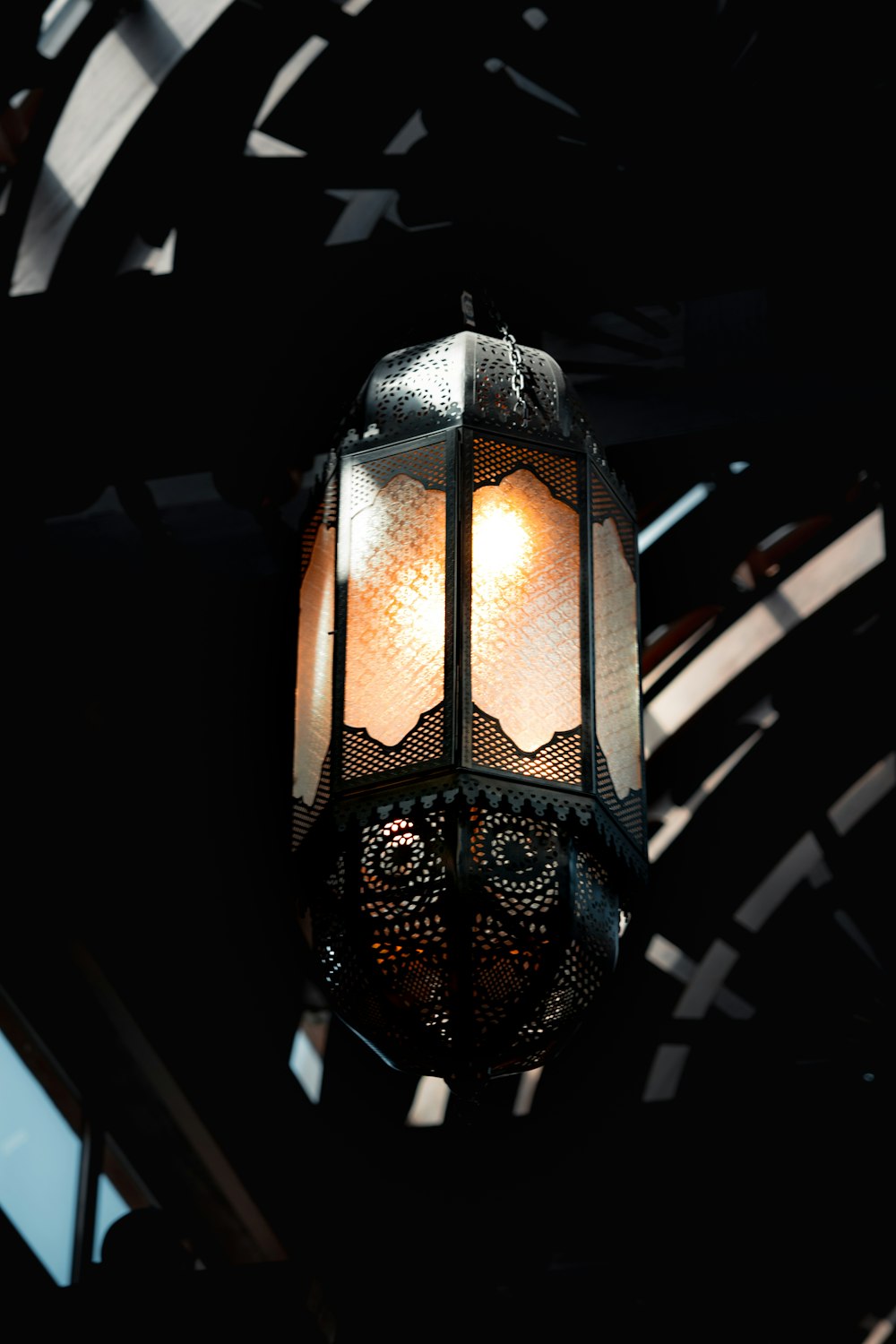 a lamp hanging from the ceiling of a building
