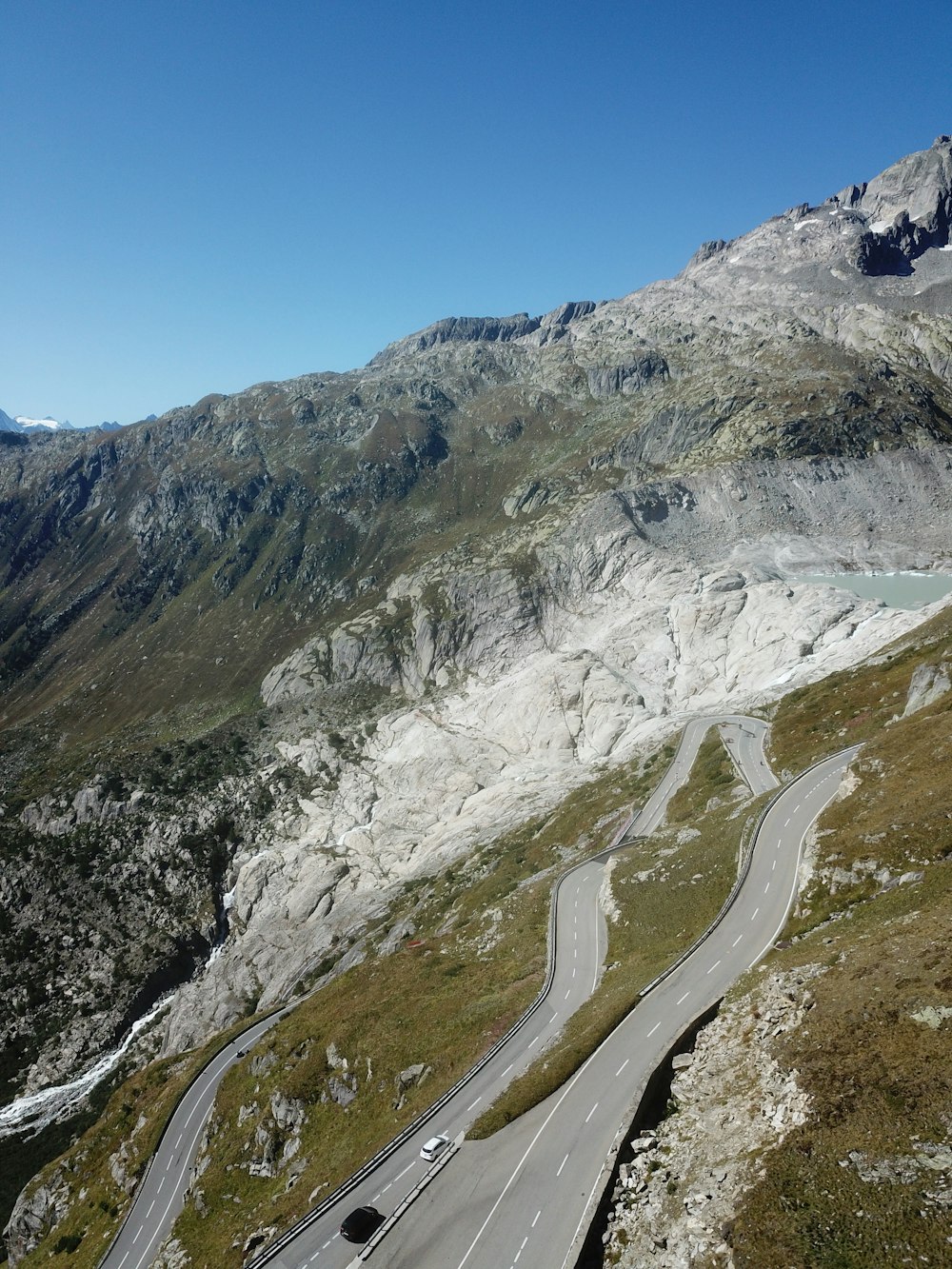 a car driving down a winding road in the mountains