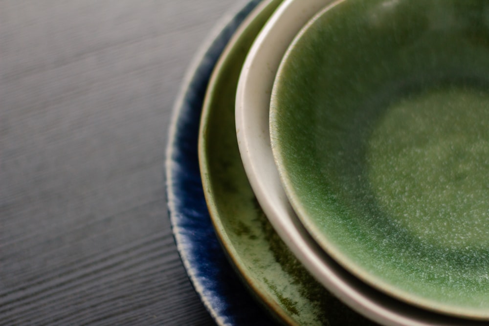 a close up of a green and white plate on a table