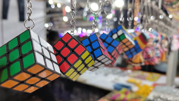 A shelf displaying rare and limited-edition Rubik's cubes in vibrant colors.