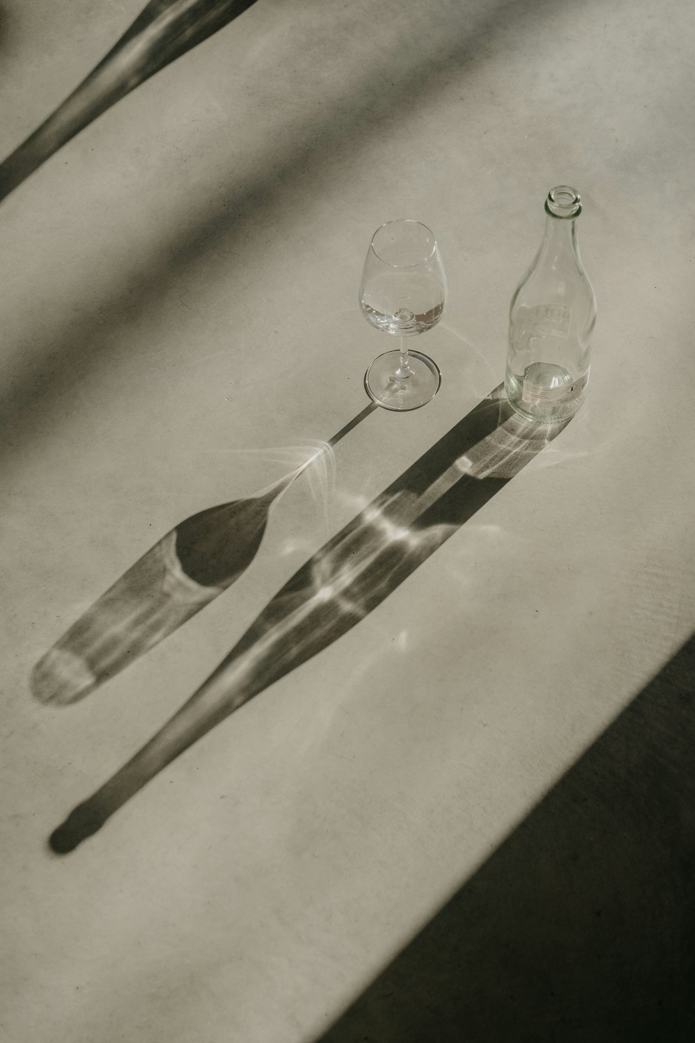 a table with a spoon and a bottle on it
