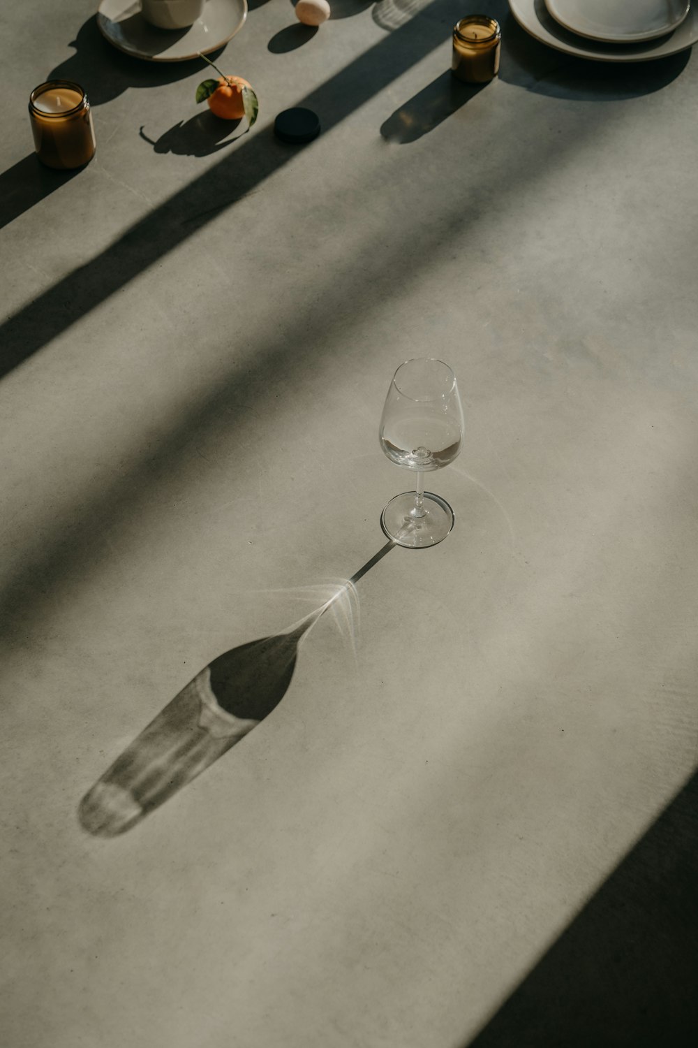 a table topped with two wine glasses and plates