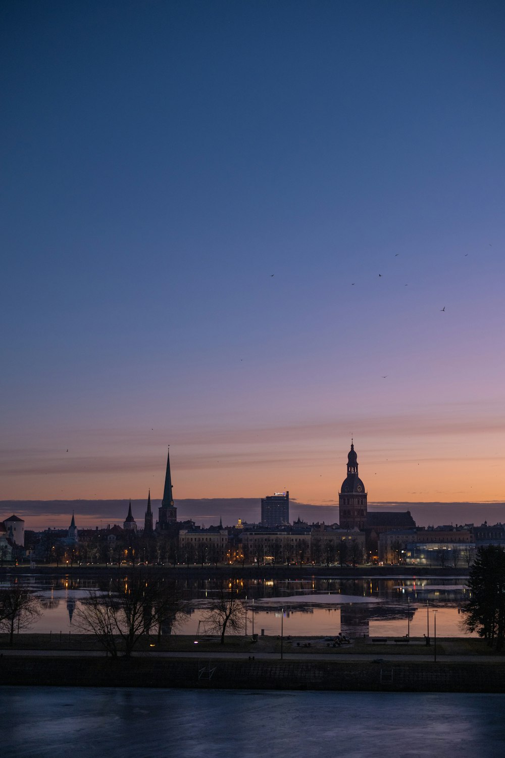 a view of a city at dusk with a river running through it