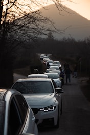a line of cars parked on the side of a road