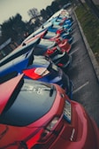 A lineup of colorful Chinese compact cars displayed outdoors.