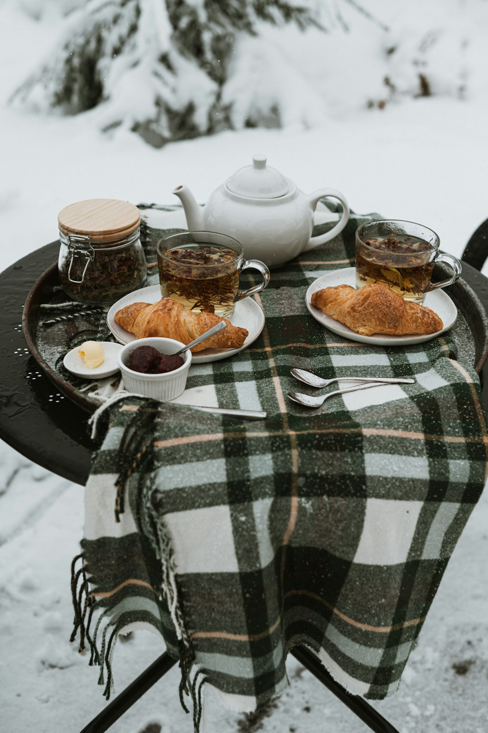 a table topped with a plate of food next to a cup of coffee