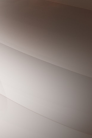 Gentle curves form subtle, layered patterns, creating an abstract and minimalist aesthetic.