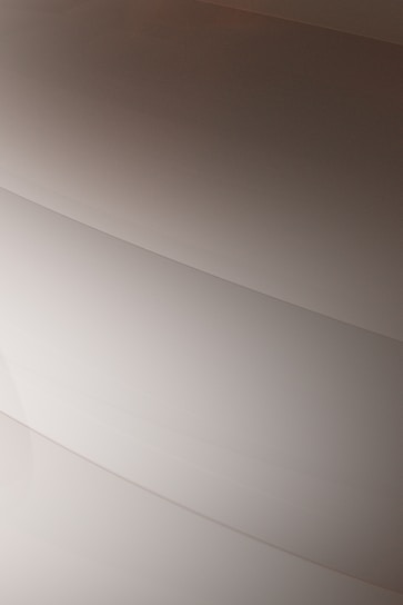 Gentle curves form subtle, layered patterns, creating an abstract and minimalist aesthetic.