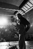 Black and white photo of Kentenfromlucca lost in music during an intimate gig.