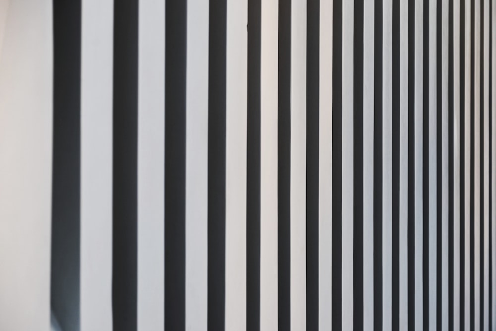 a black and white striped wall next to a window