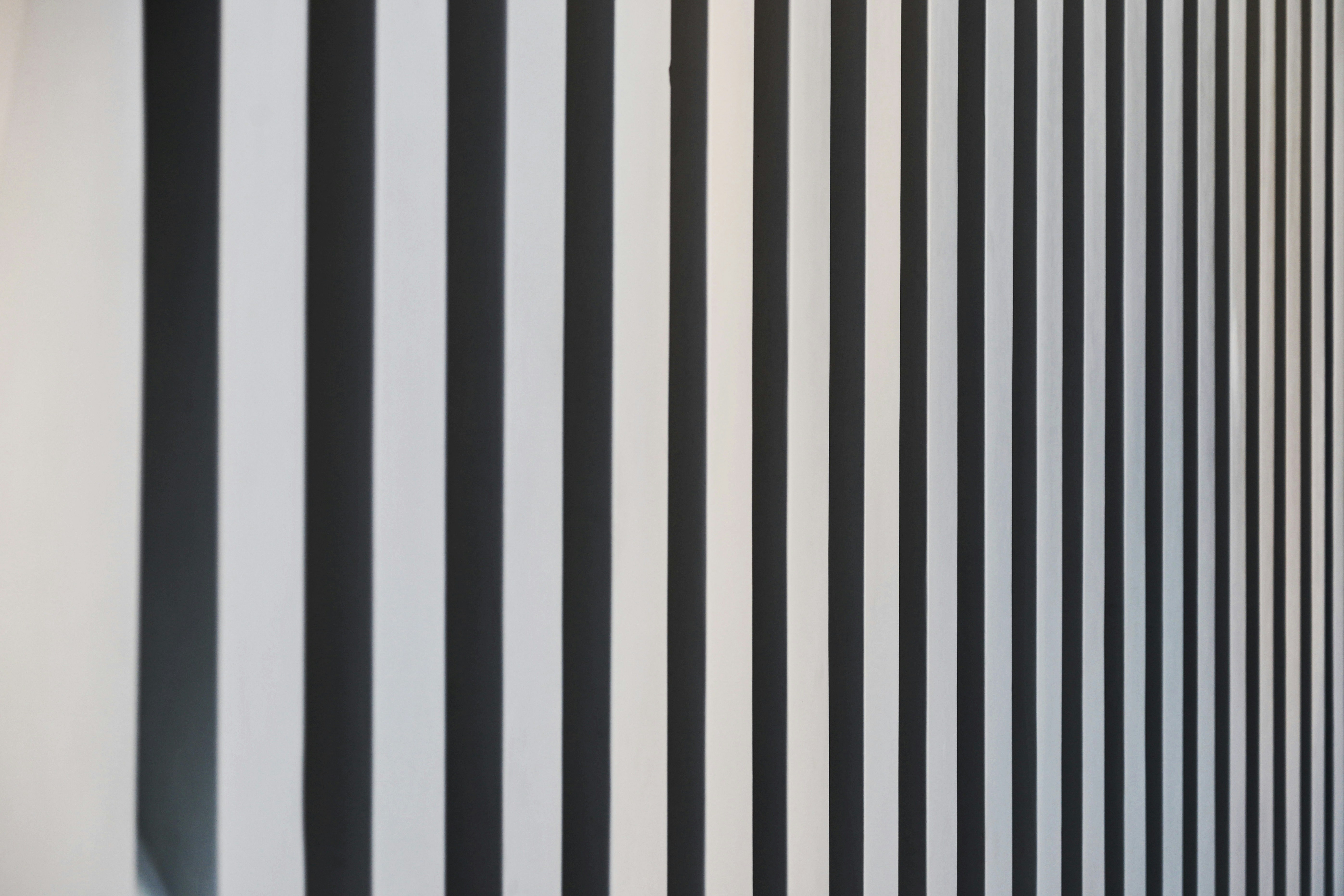 a black and white striped wall next to a window