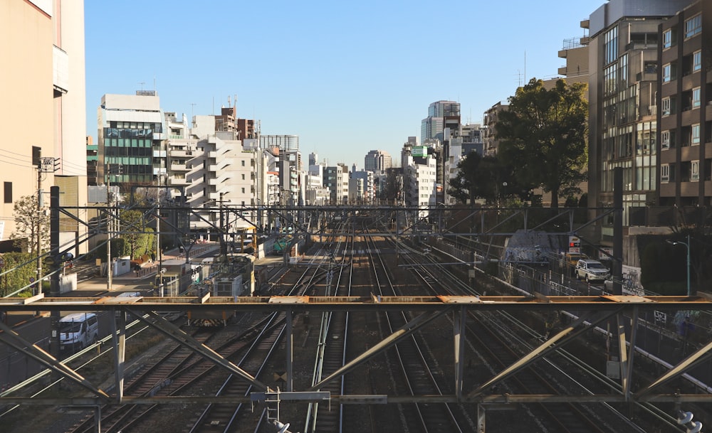 a train track running through a city with tall buildings