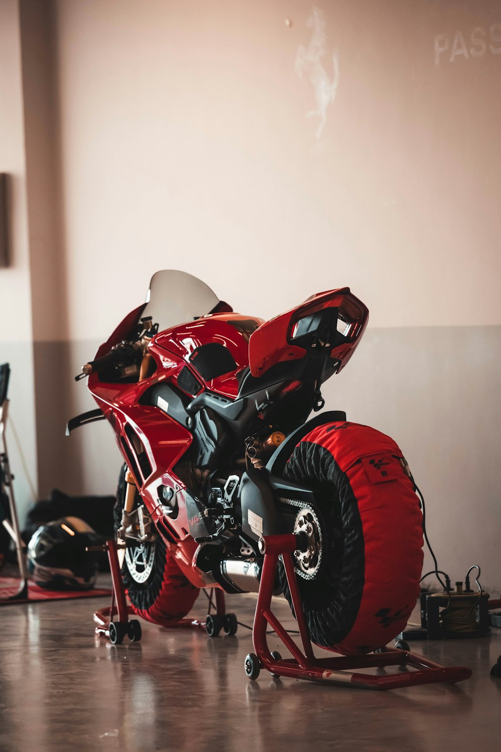 a red motorcycle is parked in a room