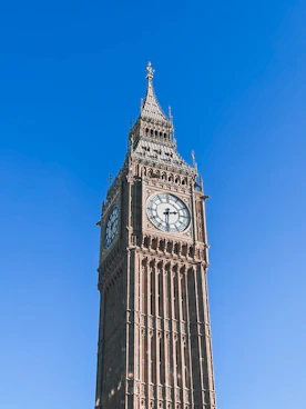 a tall clock tower with a clock on each of it's sides
