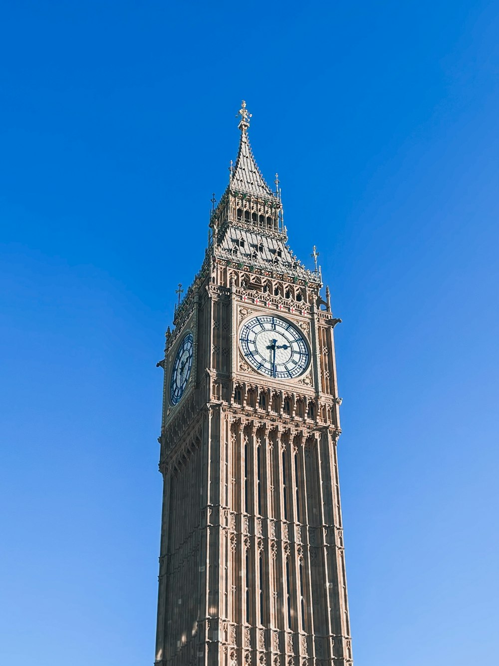 a tall clock tower with a clock on each of it's sides