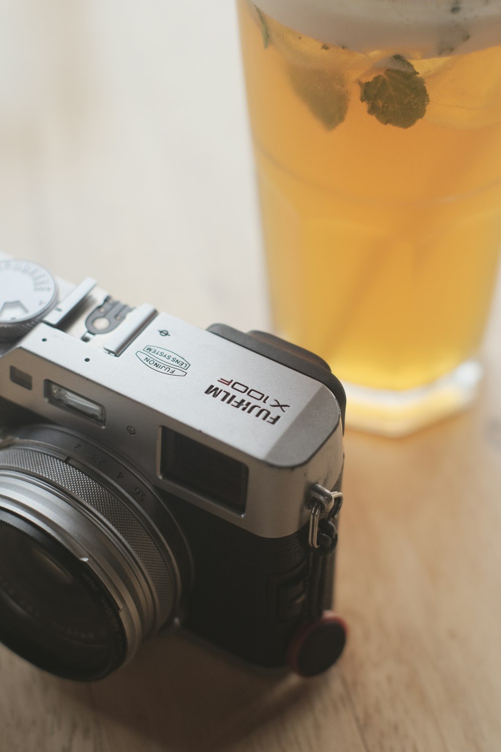 a camera and a glass of beer on a table