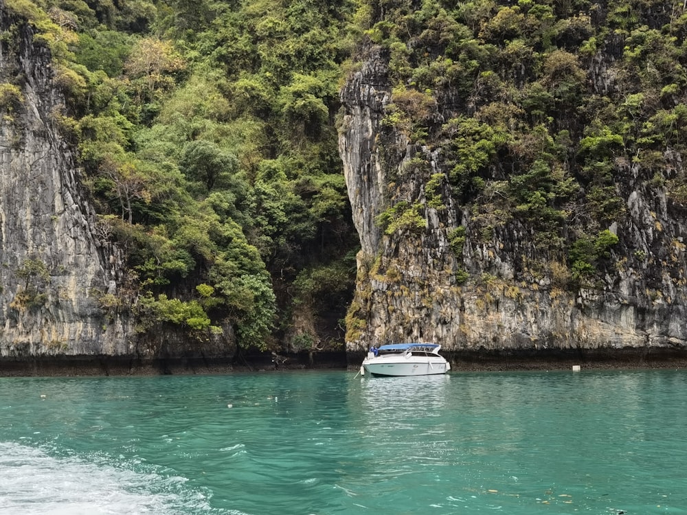 a small boat in the middle of a body of water