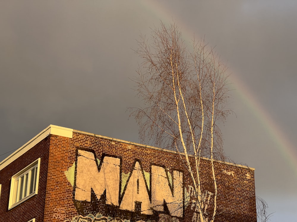 a brick building with a rainbow in the background