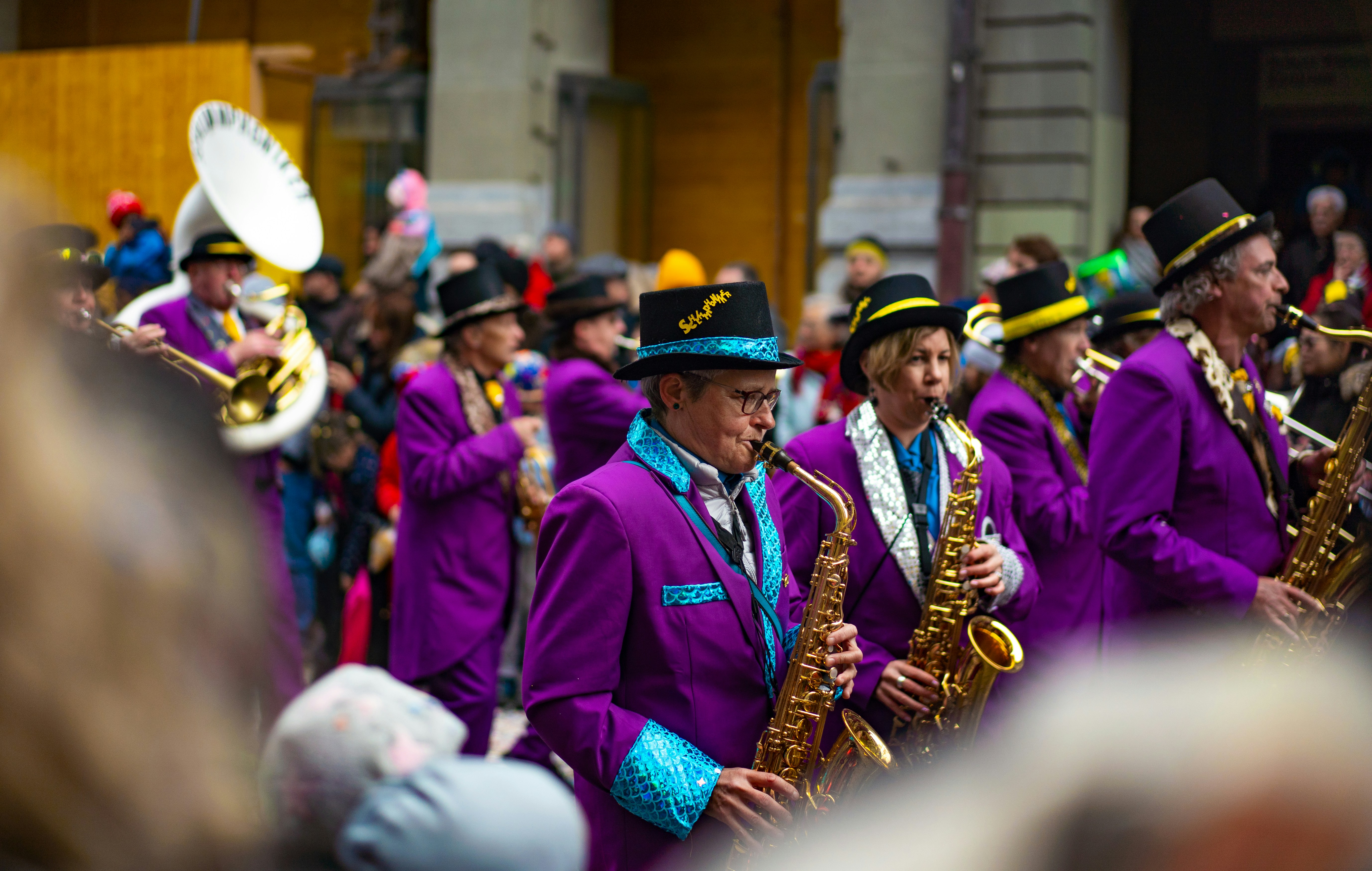 A group of men in purple suits and hats playing musical instruments ...