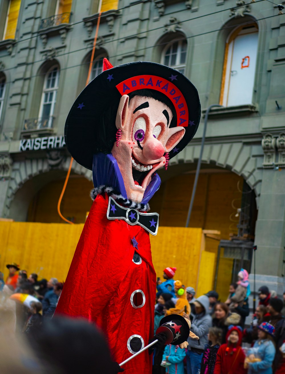 a man dressed in a red costume and a black hat