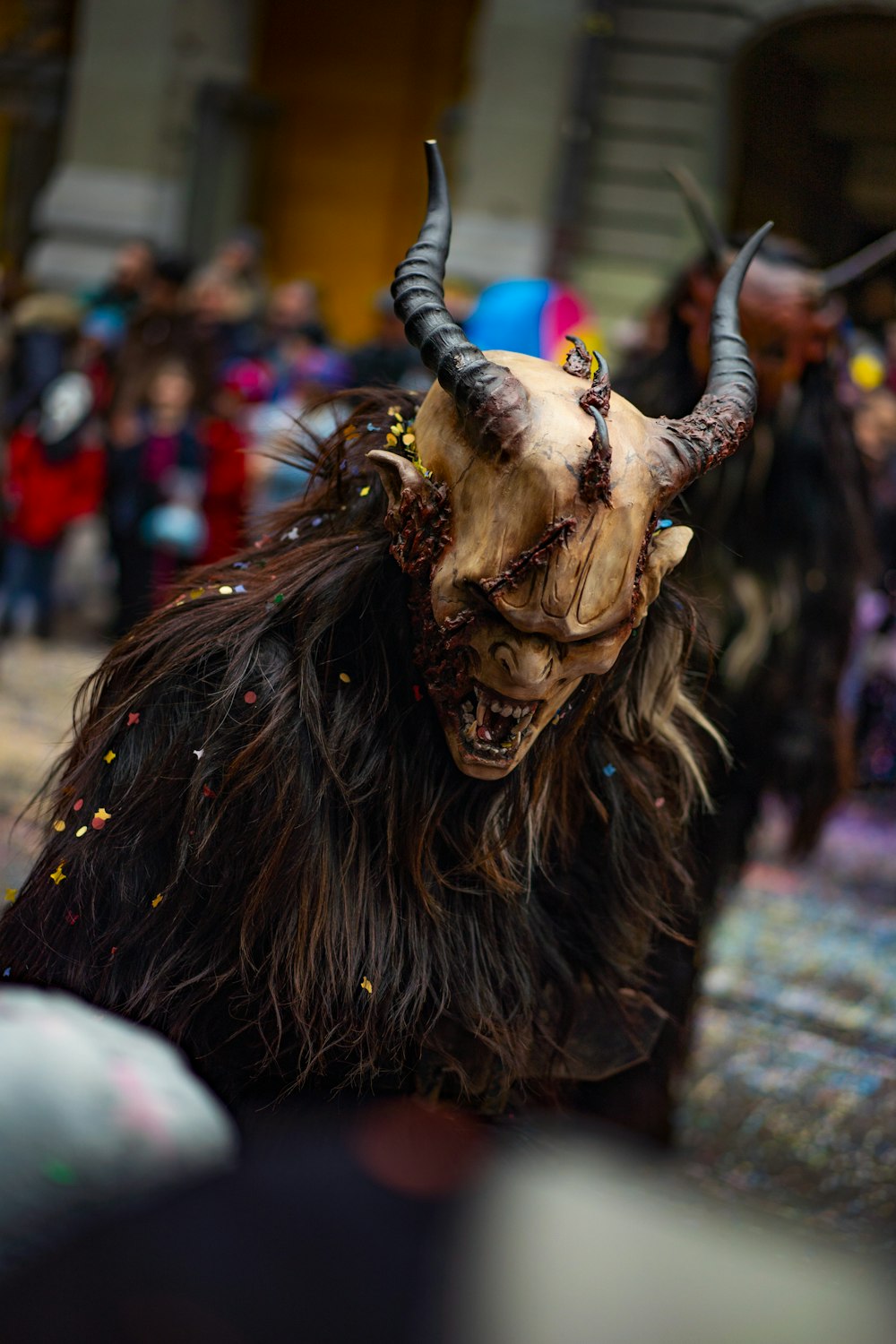 a horned animal with horns and long hair