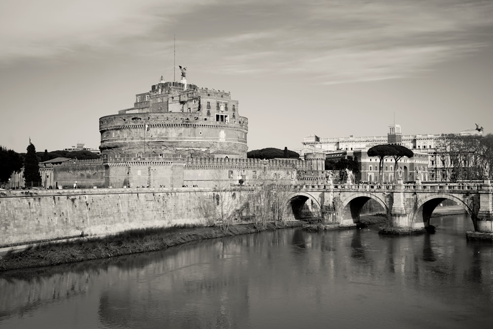 a black and white photo of a bridge and a castle