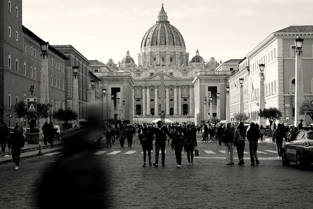 a group of people walking across a street