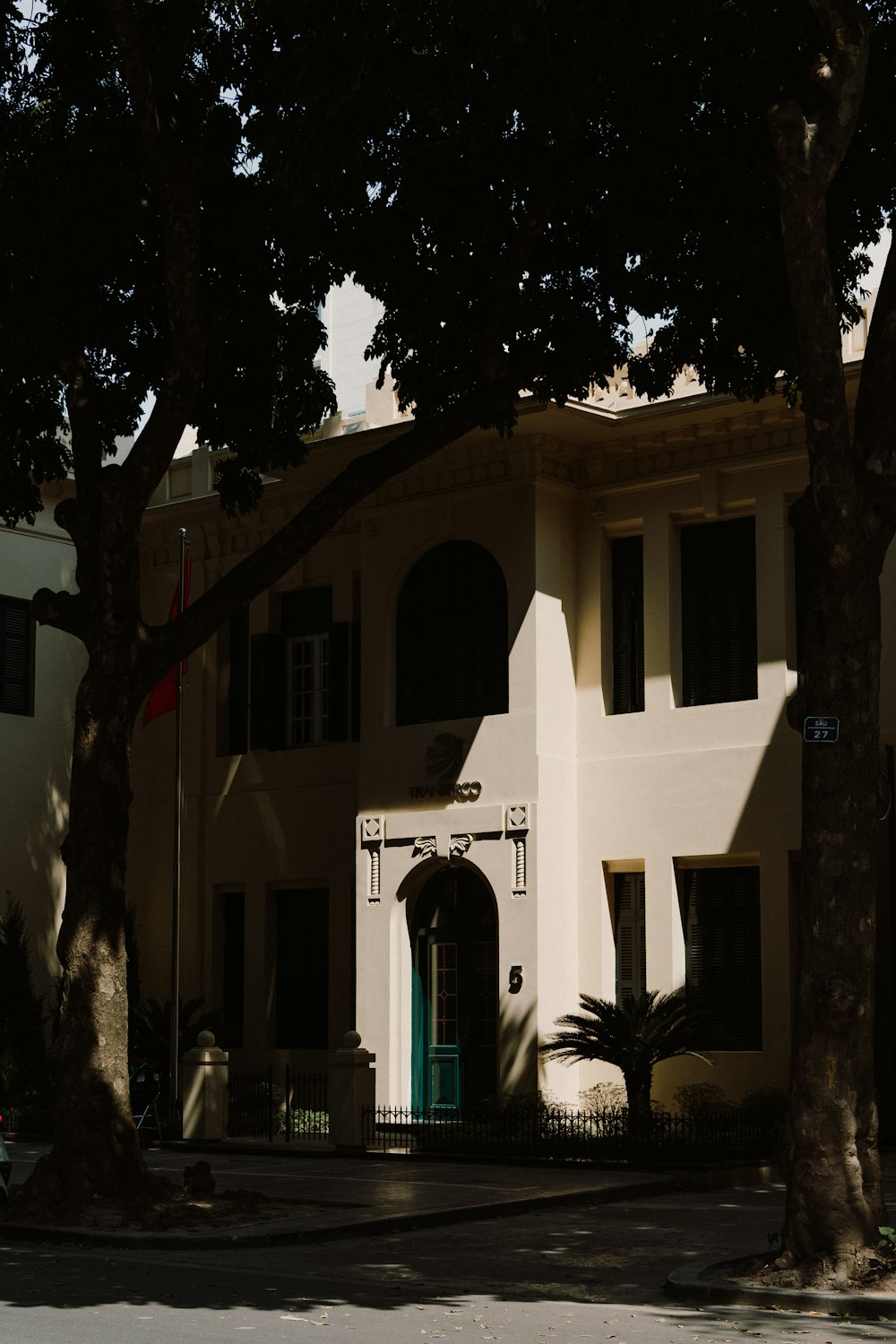 a large white house with a green door