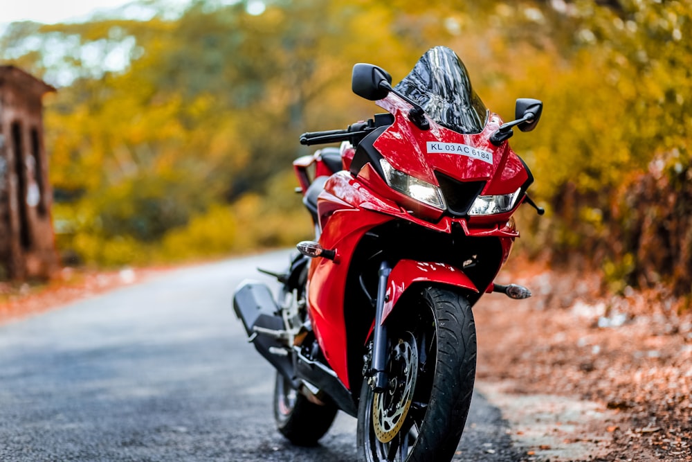 a red motorcycle parked on the side of a road