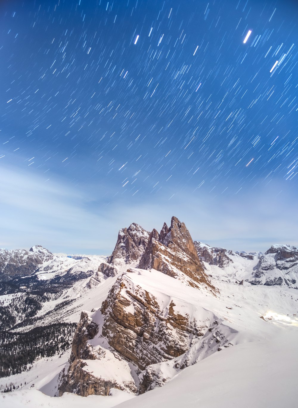 a snow covered mountain with stars in the sky